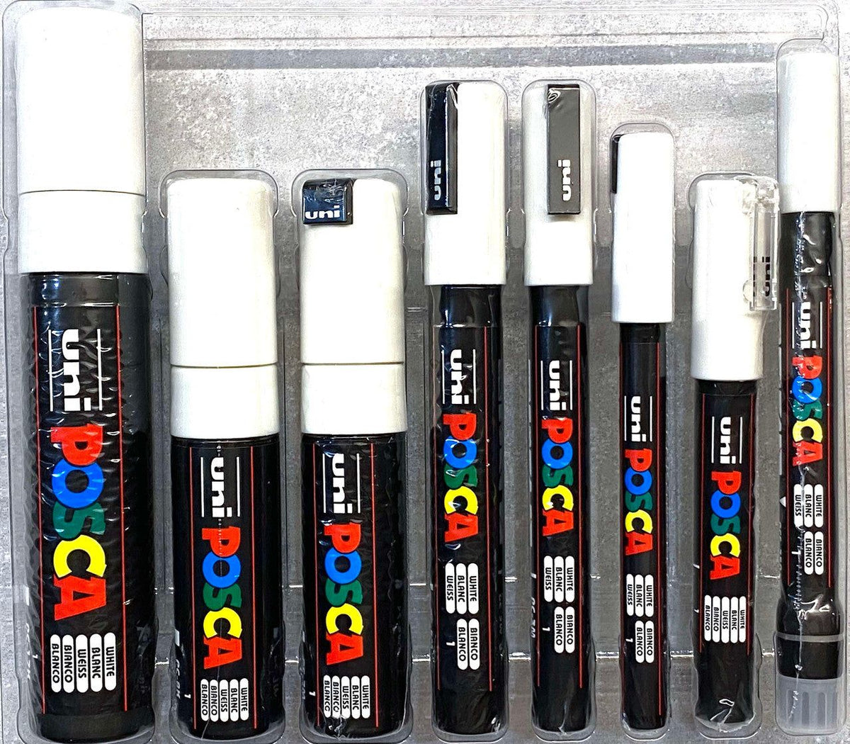 POSCA Assorted Marker Tips In White, showing eight real POSCA white markers