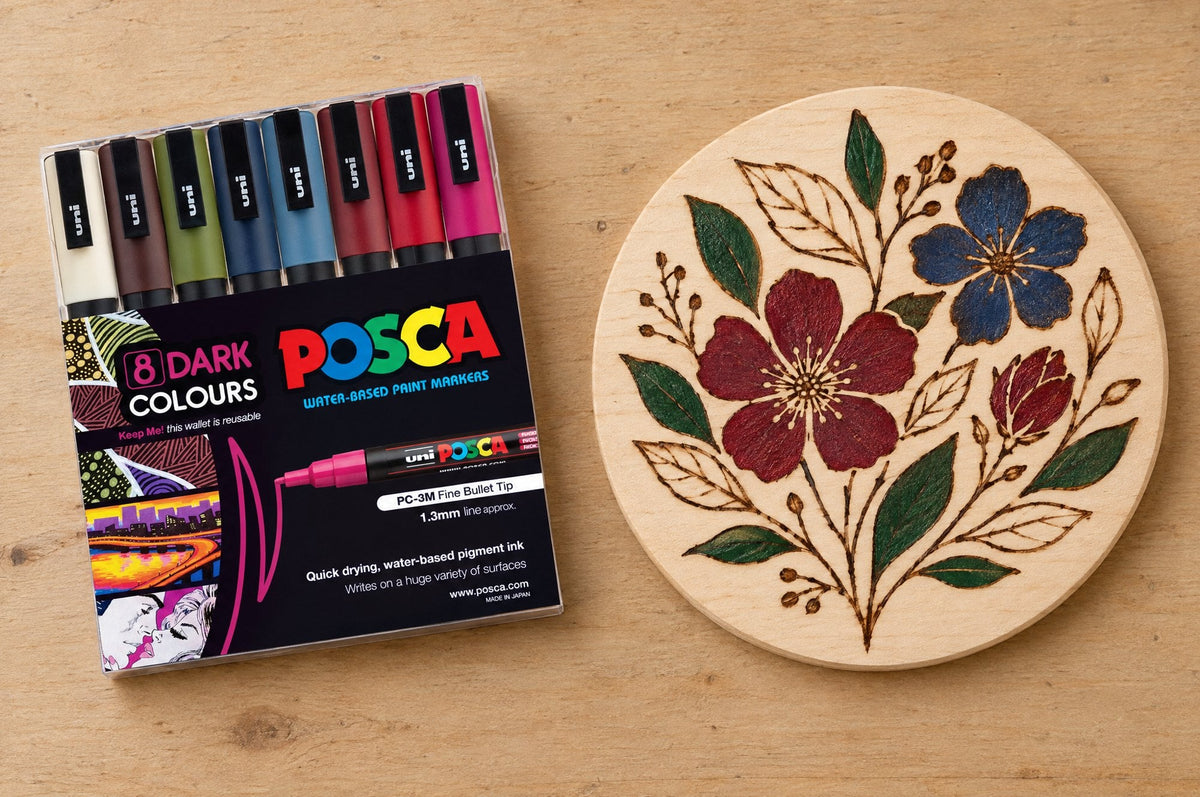 POSCA PC-3M Dark Colour Tones wallet beside a pyrography timber panel filled with POSCA colour