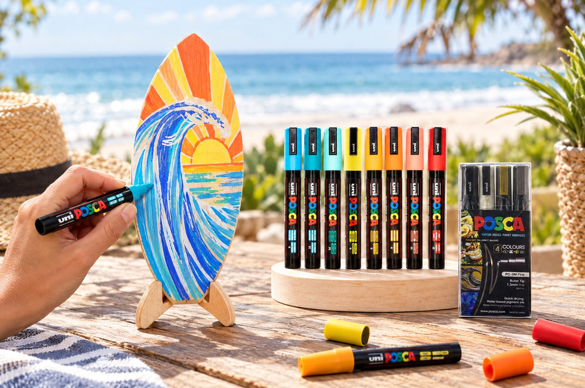POSCA markers decorating a wooden surfboard on its stand