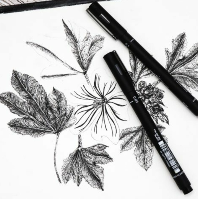 uni PIN black fineliner pens laid out by tip size