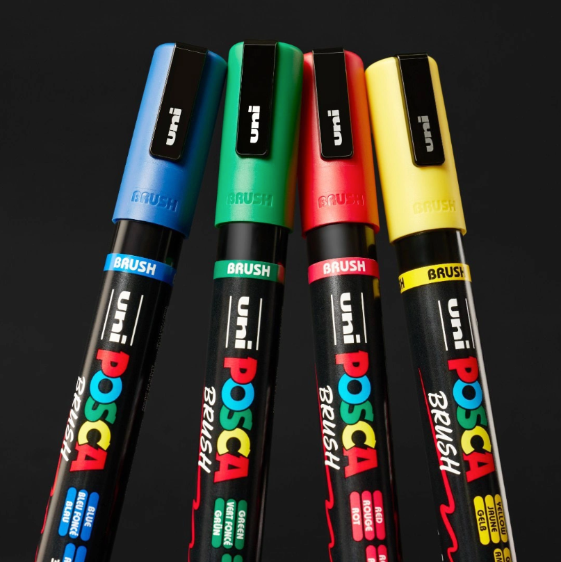 Four POSCA PC-5BR brush markers in blue, green, red and yellow with matching caps