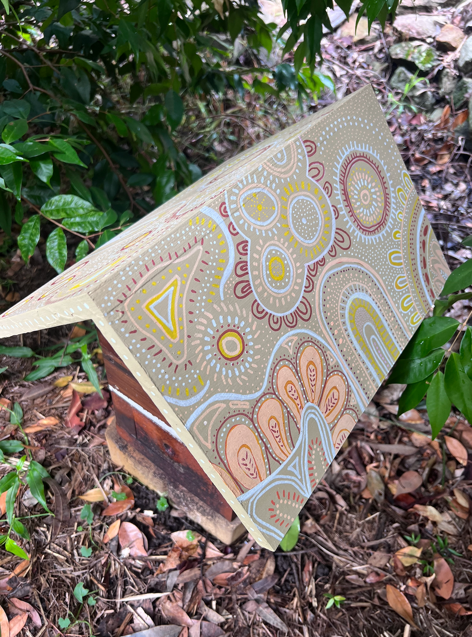 Beehive roof painted with earth tone patterns using POSCA markers