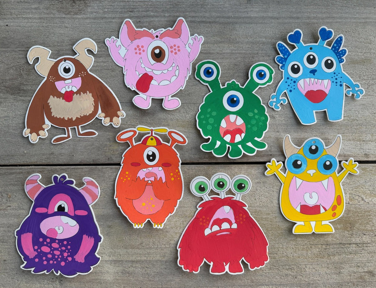PoscART colour in monster cards set of 8, eight coloured monster characters on a wooden surface