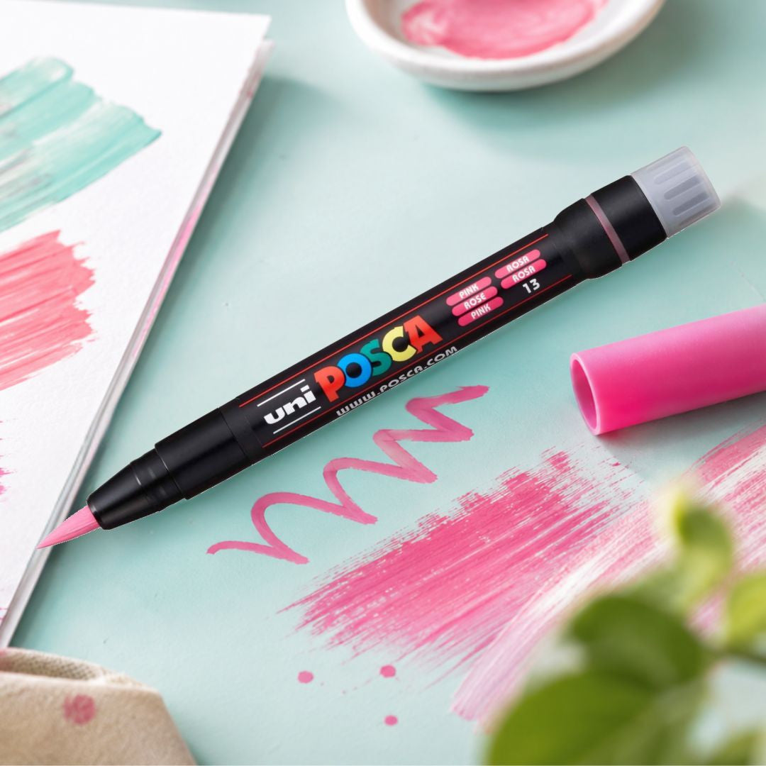 POSCA PCF-350 pink brush marker on a pastel workspace