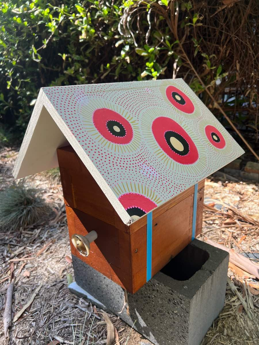 Beehive roof painted with pink circles using POSCA markers