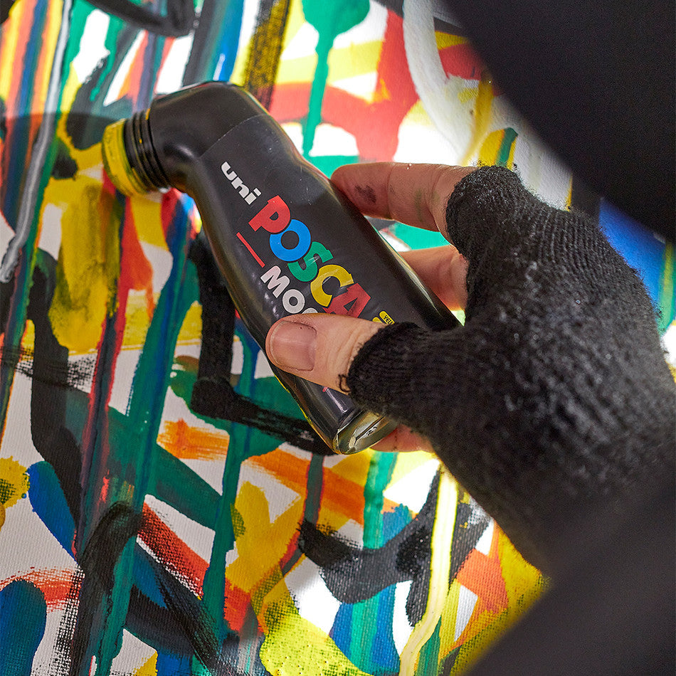 Artist using POSCA MOP'R PCM-22 for bold strokes on a colourful mural
