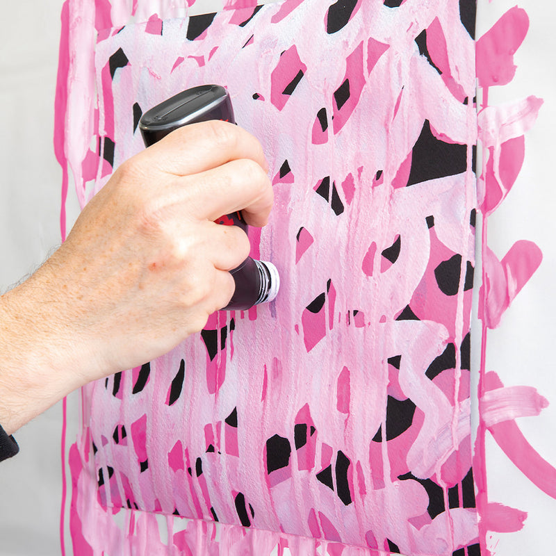 Artist applying pink POSCA MOP'R PCM-22 paint to a wall
