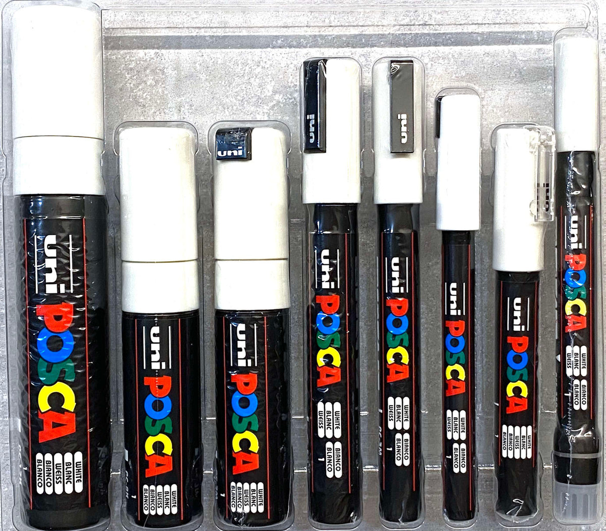 POSCA white markers standing in size order