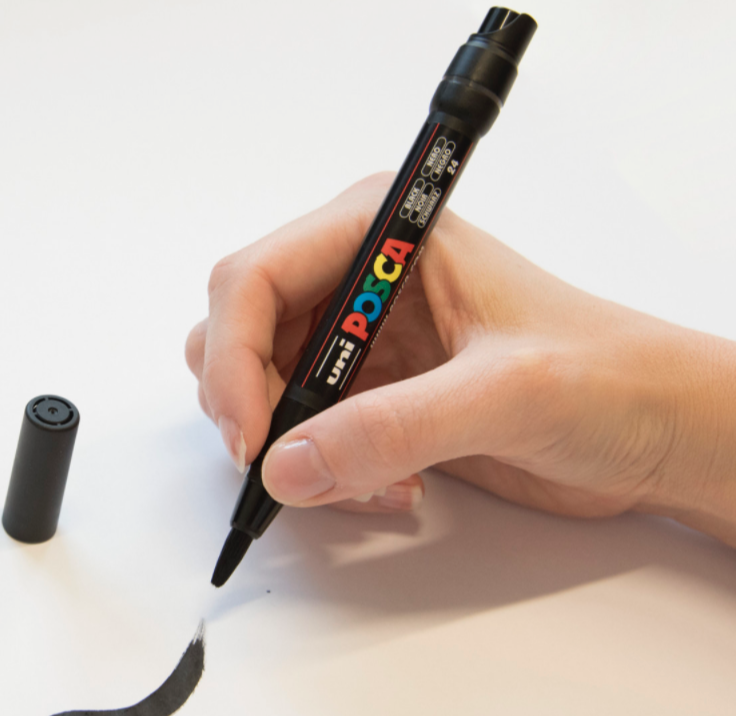 Artist writing calligraphy with a POSCA PCF-350 brush tip marker