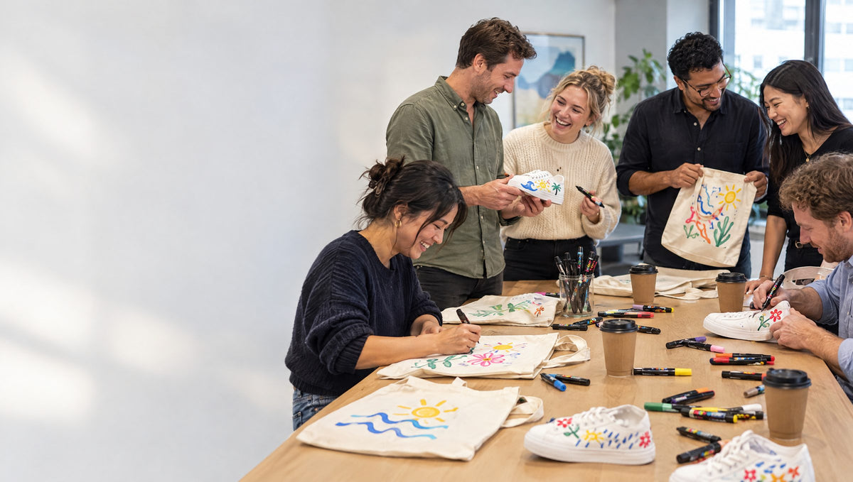 Staff team-building session decorating sneakers and tote bags with paint markers